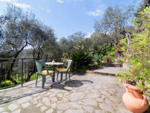 a patio with two chairs and a table at Holiday Home Candy by Interhome in Nerano