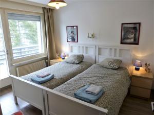 a bedroom with two beds with towels on them at Apartment Cransalpin-1 by Interhome in Vermala