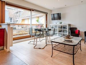 a living room with a table and chairs at Apartment Les Cigognes by Interhome in Deauville