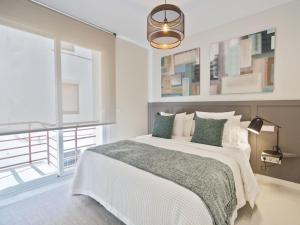 Ένα ή περισσότερα κρεβάτια σε δωμάτιο στο Sitges Spaces Deluxe Comfort Flat-Monthly Rentals