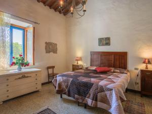 a bedroom with a bed and a dresser and a window at Apartment Fattoria Petraglia - Terrazza by Interhome in Monteriggioni