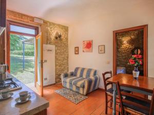 a living room with a couch and a table at Apartment Fattoria Petraglia - Cedro by Interhome in Monteriggioni