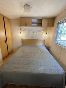 a bedroom with a bed in a small room at Charmant Mobile Home en foret in Braize