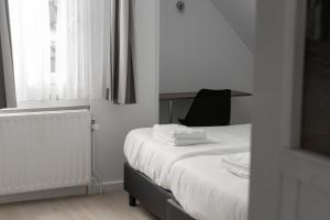Uma cama ou camas num quarto em Hotel de la Bourse