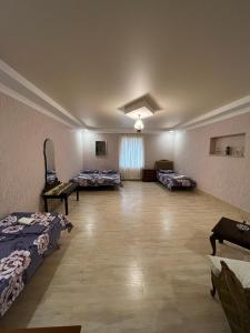 a large room with three beds in it at Kutaisi City Heart Apartment in Kutaisi
