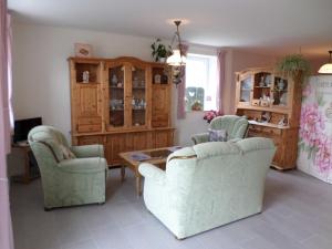 a living room with two chairs and a table at Haus Sonnenhof am Dollart 45240 in Ditzumerhammrich