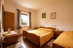 a bedroom with two beds and a window at Apartments Jadranka in Medulin