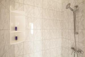 a bathroom with a shower with a shower head at Apartments Jadranka in Medulin