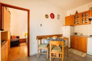 a kitchen with a small table and chairs in a room at Apartments Jadranka in Medulin +22 photos