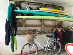 a bike parked next to surfboards on a wall at Maison vue mer à GUETHARY 7 personnes in Bidart