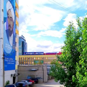 un edificio con un mural de una mujer en él en 4-х комнатная квартира Центр ЦУМ, en Kostanái