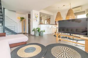 a living room with a large flat screen tv at Mar Colonia in Colonia Sant Jordi