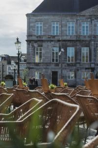 a row of chairs in front of a building at Hotel de la Bourse in Maastricht