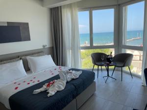 Postel nebo postele na pokoji v ubytování Hotel Petit Palais