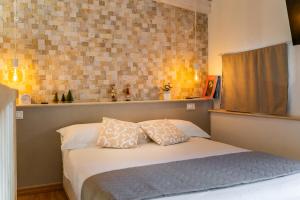 a bedroom with a bed with two pillows on it at Loft 35 - private parking in Quartu SantʼElena