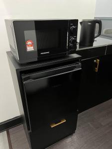 a microwave oven sitting on top of a counter at SAMSARA Studio Apartment with Pool in Gua Musang