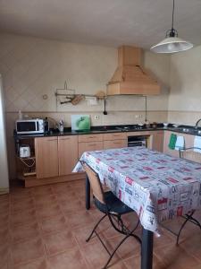 a kitchen with a table with a table cloth on it at Can ventura in Deltebre