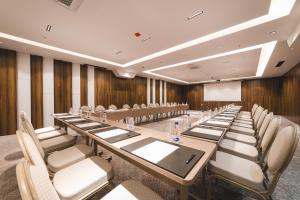 a conference room with a long table and chairs at Bristol Hotel Podgorica in Podgorica