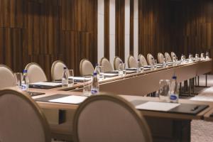 a row of tables and chairs in a room at Bristol Hotel Podgorica in Podgorica