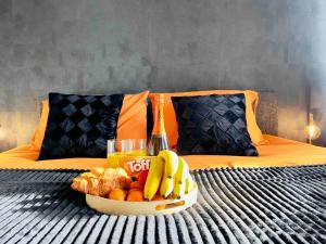 a tray of fruit on top of a bed at Central Luton apartment by Hostaguest in Luton