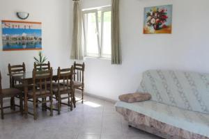 ein Wohnzimmer mit einem Tisch und einem Sofa in der Unterkunft Apartment in Razanj with sea view, terrace, air conditioning, WiFi 5150-2 in Ražanj