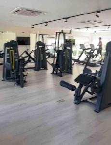 a gym with several rows of treadmills and machines at Grand Baie - Très belle villa 3 chambres in Grand-Baie