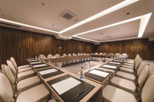 a conference room with a long table and chairs at Bristol Hotel Podgorica in Podgorica