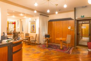 a room with tables and chairs and a bar at Hotel City Center in Palermo