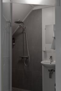a bathroom with a shower and a sink at Hotel de la Bourse in Maastricht