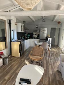 a kitchen and living room with a table and chairs at Appartement St Victor in Puyvert