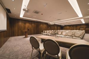 a conference room with a long table and chairs at Bristol Hotel Podgorica in Podgorica