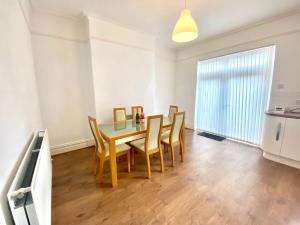 a dining room with a table and chairs at Merseyside in Birkenhead