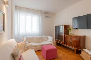 a living room with a couch and a tv at BnButler - Verona 12, Porta Romana District in Milan