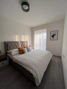 a bedroom with a large bed with white sheets and a window at Rivapark in Dunajská Streda +44 photos