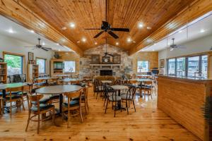 a dining room with tables and chairs and a fireplace at Los Lagos at Hot Springs Village a Ramada by Wyndham in Hot Springs Village