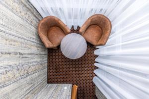 a room with two wooden stools on the wall at Resort Hotel Elija in Šventoji