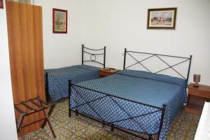 Ένα ή περισσότερα κρεβάτια σε δωμάτιο στο Albergo Pensione Ardenza SELF CHECK-IN