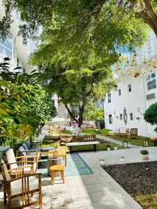 a patio with a bunch of chairs and tables at Aqua Hotel in Fort Lauderdale