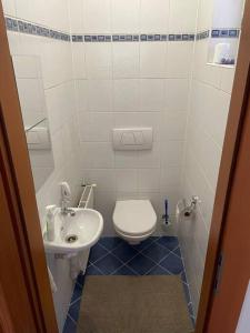 a small bathroom with a toilet and a sink at Apartmán Obchodná in Staré Mesto