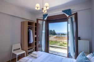 een slaapkamer met een bed en een glazen schuifdeur bij Lucid Dream Apt. |Bozinis in Psakoudia