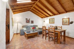 a living room with a table and a couch at El Lagar in Icod de los Vinos