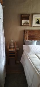 a bedroom with a bed and a table with a phone at La Casa di Marla in Sirmione