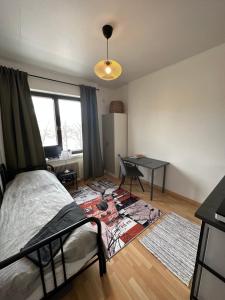 a bedroom with a bed and a desk in it at Cozy apartment in Vallila - Helsinki in Helsinki