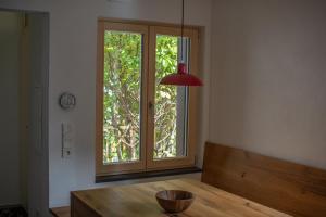 a room with a wooden table and a window at Kubus in Memmingen