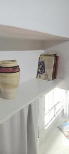 un estante con un tazón y un libro sobre él en Piran Loft en Buenos Aires