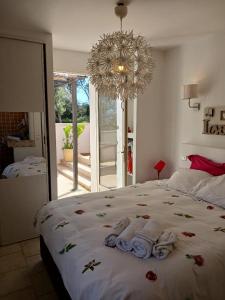 a bedroom with a large bed with towels on it at Bois Joli in Hyères