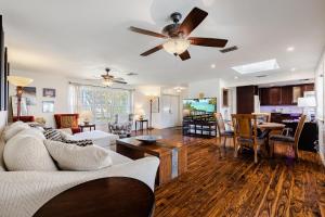 a living room with a couch and a ceiling fan at Heated Saltwater Pool, Sleeps 6 - Villa Shangri-La in Cape Coral