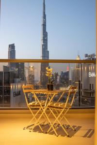 a table on a balcony with a view of a city at Elite Downtown Residences - Paradise View in Dubai