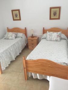 מיטה או מיטות בחדר ב-Casa Gloria 2