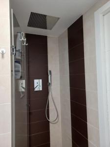 a bathroom with a shower with brown tiles at Loft Nou Benicalap in Valencia